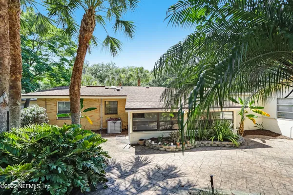 a view of a patio with chairs and potted plants