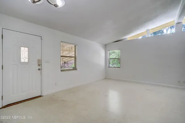 a view of an empty room with a window