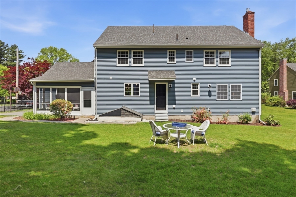 94 Johnson Road Winchester, MA 01890 - Photo 33 of 40 a front view of a house with a yard table and chairs