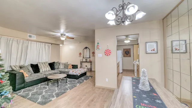 a living room with furniture and a chandelier