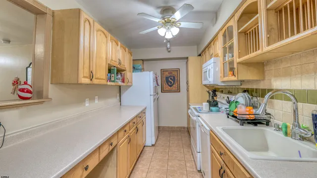 a kitchen with a sink a stove and cabinets