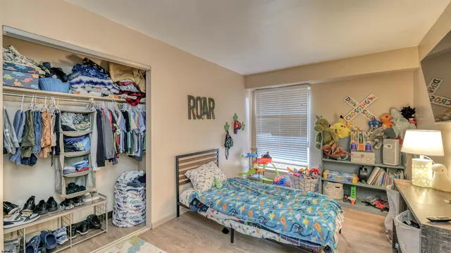 a bedroom with two beds and a bed