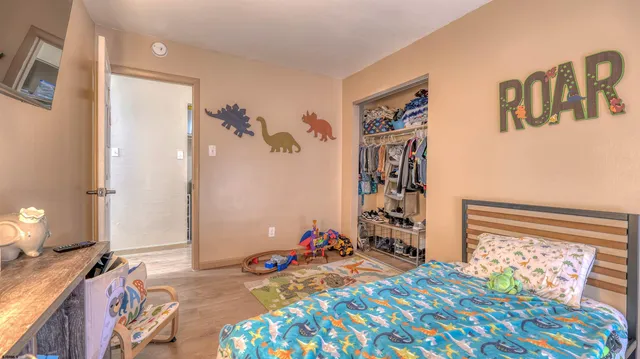 a bedroom with a bed and a window