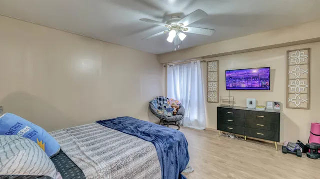 a bedroom with a bed and a chandelier