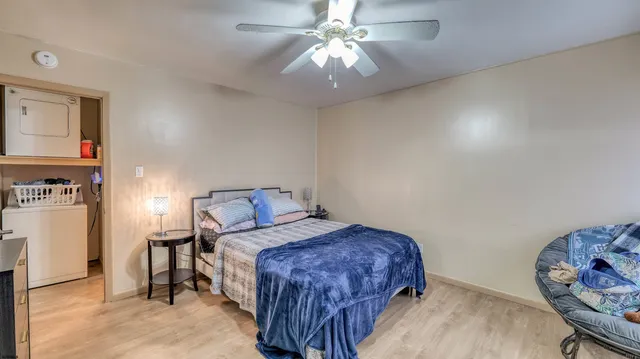 a bedroom with a bed and a chandelier