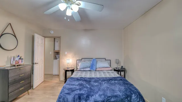 a bedroom with a bed and a chandelier