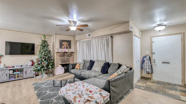 a living room with furniture and a flat screen tv