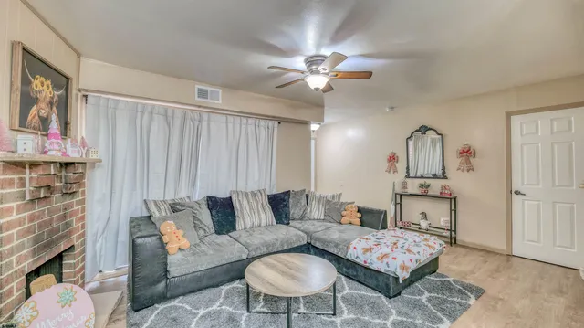 a living room with furniture a rug and a chandelier