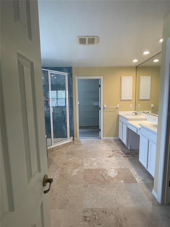 759 Fordingbridge Way Osprey, FL 34229 - Photo 11 of 51 a large bathroom with a granite countertop sink a large mirror and a shower