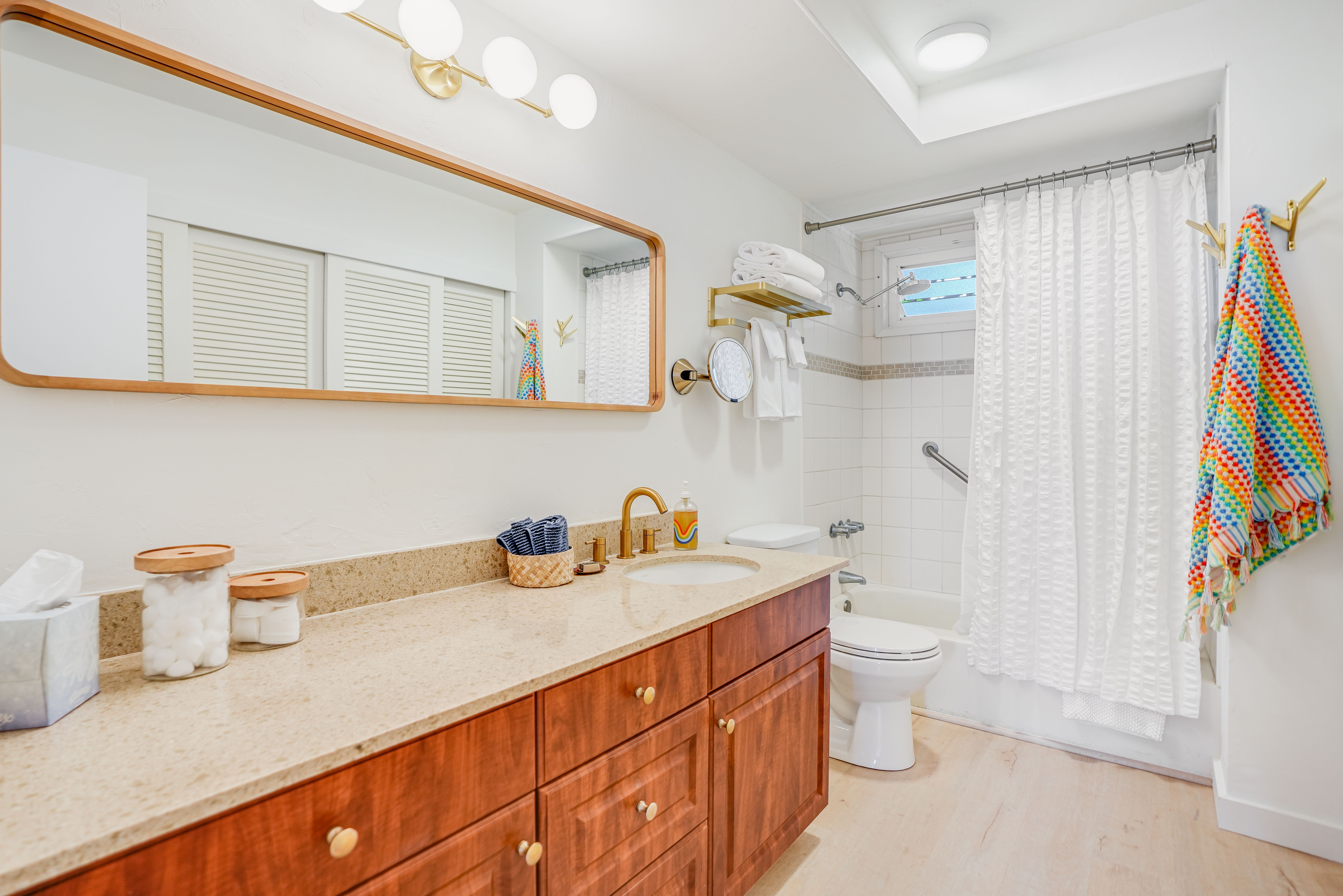 1763 Pe'e Road, Unit 203 Koloa, HI 96756 - Photo 12 of 27 a bathroom with a sink a toilet and a shower curtain