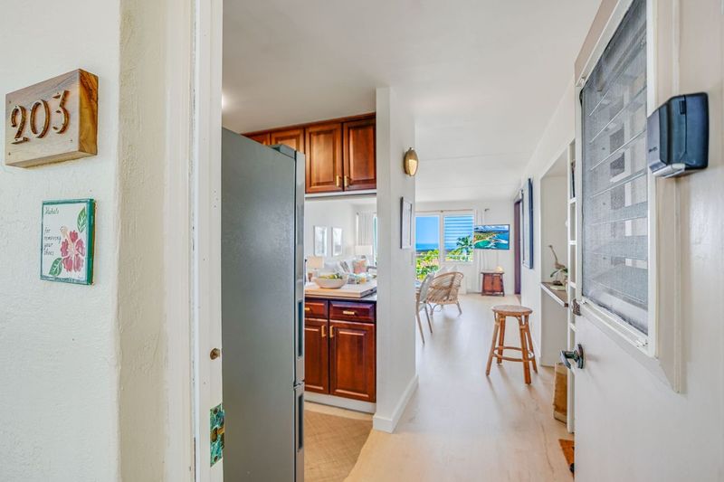 1763 Pe'e Road, Unit 203 Koloa, HI 96756 - Photo 13 of 27 a dining room with furniture and a fireplace