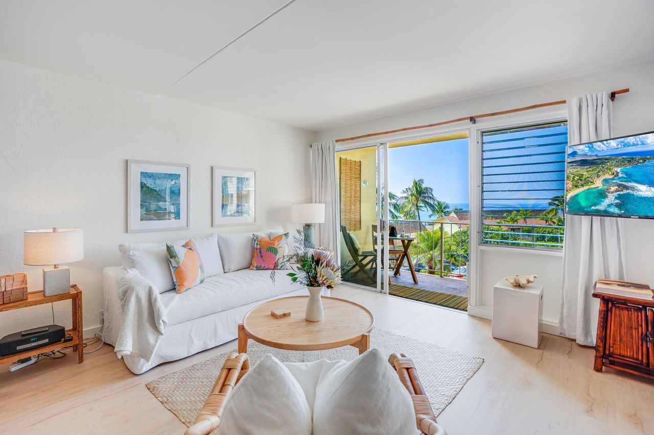 1763 Pe'e Road, Unit 203 Koloa, HI 96756 - Photo 14 of 27 a living room with furniture a bed and a potted plant