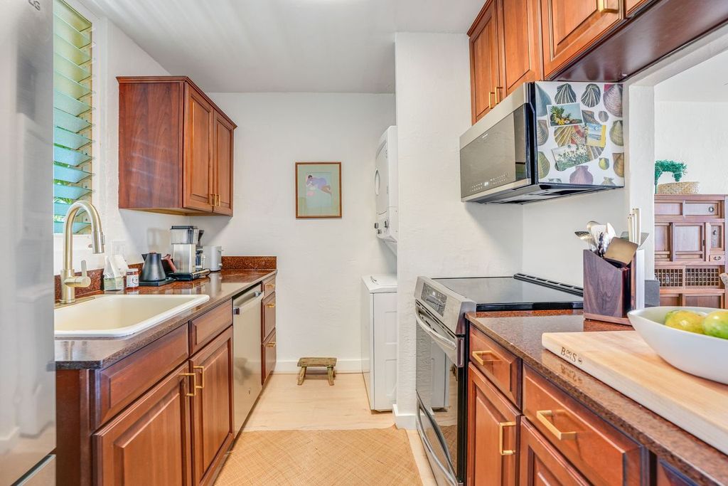 1763 Pe'e Road, Unit 203 Koloa, HI 96756 - Photo 16 of 27 a kitchen that has a sink and a stove