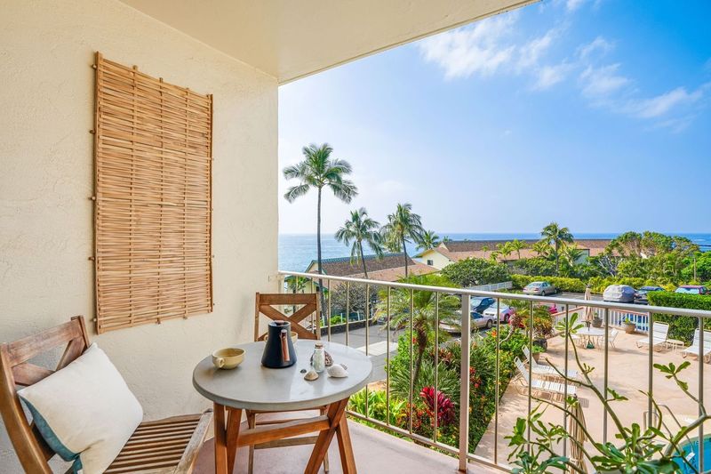 1763 Pe'e Road, Unit 203 Koloa, HI 96756 - Photo 18 of 27 a balcony with table and chairs