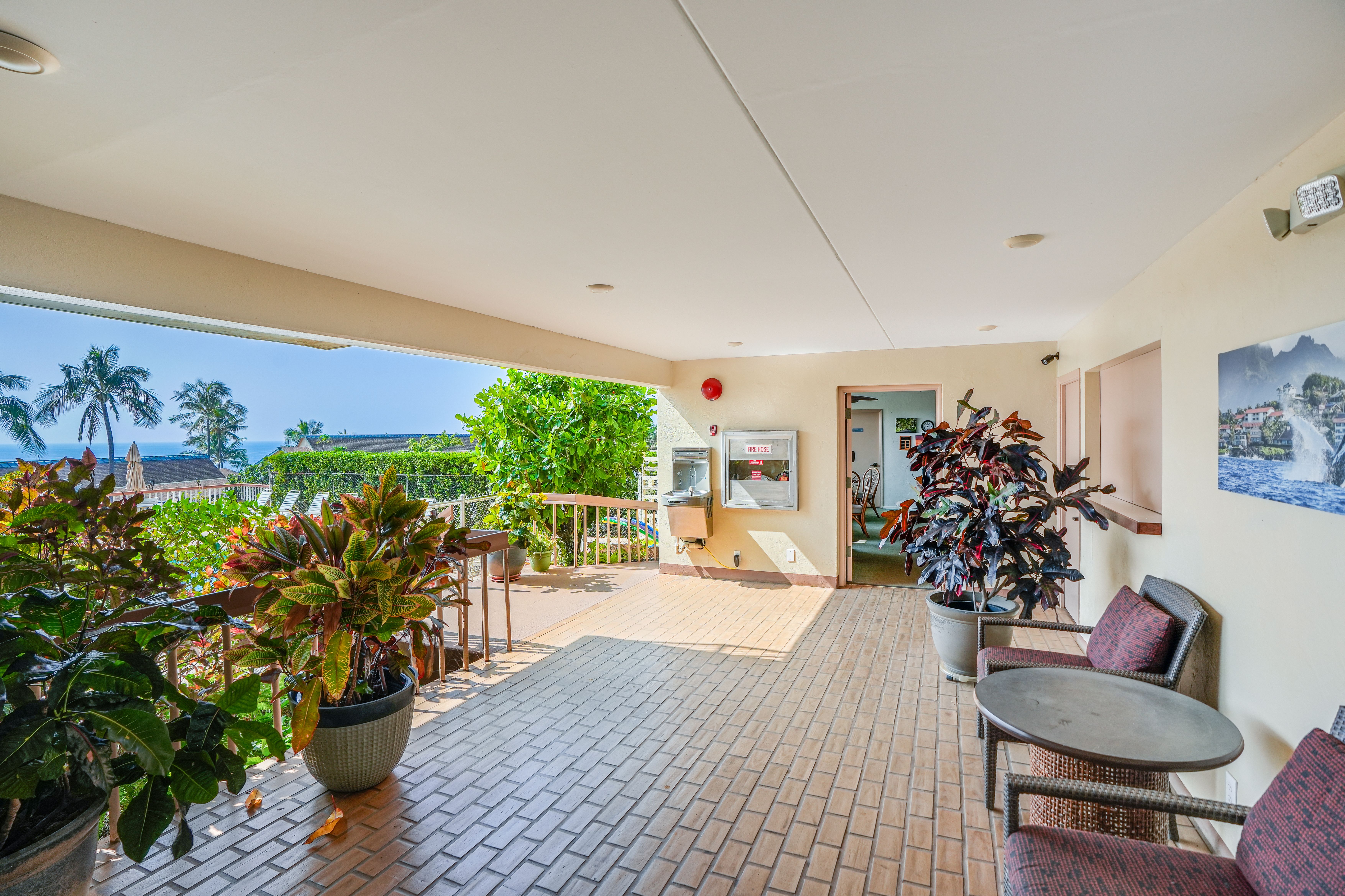 1763 Pe'e Road, Unit 203 Koloa, HI 96756 - Photo 20 of 27 a living room with furniture and flowers