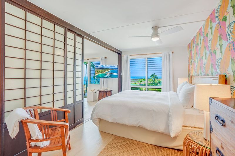 1763 Pe'e Road, Unit 203 Koloa, HI 96756 - Photo 4 of 27 a bedroom with a bed and wooden floor