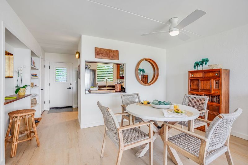 1763 Pe'e Road, Unit 203 Koloa, HI 96756 - Photo 8 of 27 a view of a dining room with furniture and a clock