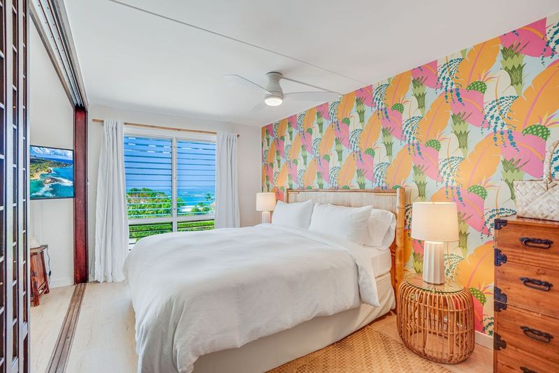1763 Pe'e Road, Unit 203 Koloa, HI 96756 - Photo 9 of 27 a bed sitting in a bedroom next to a window