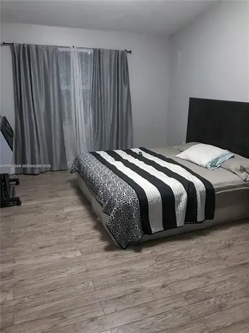 a living room with furniture window and wooden floor