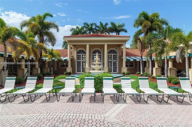 a room with pool table and windows