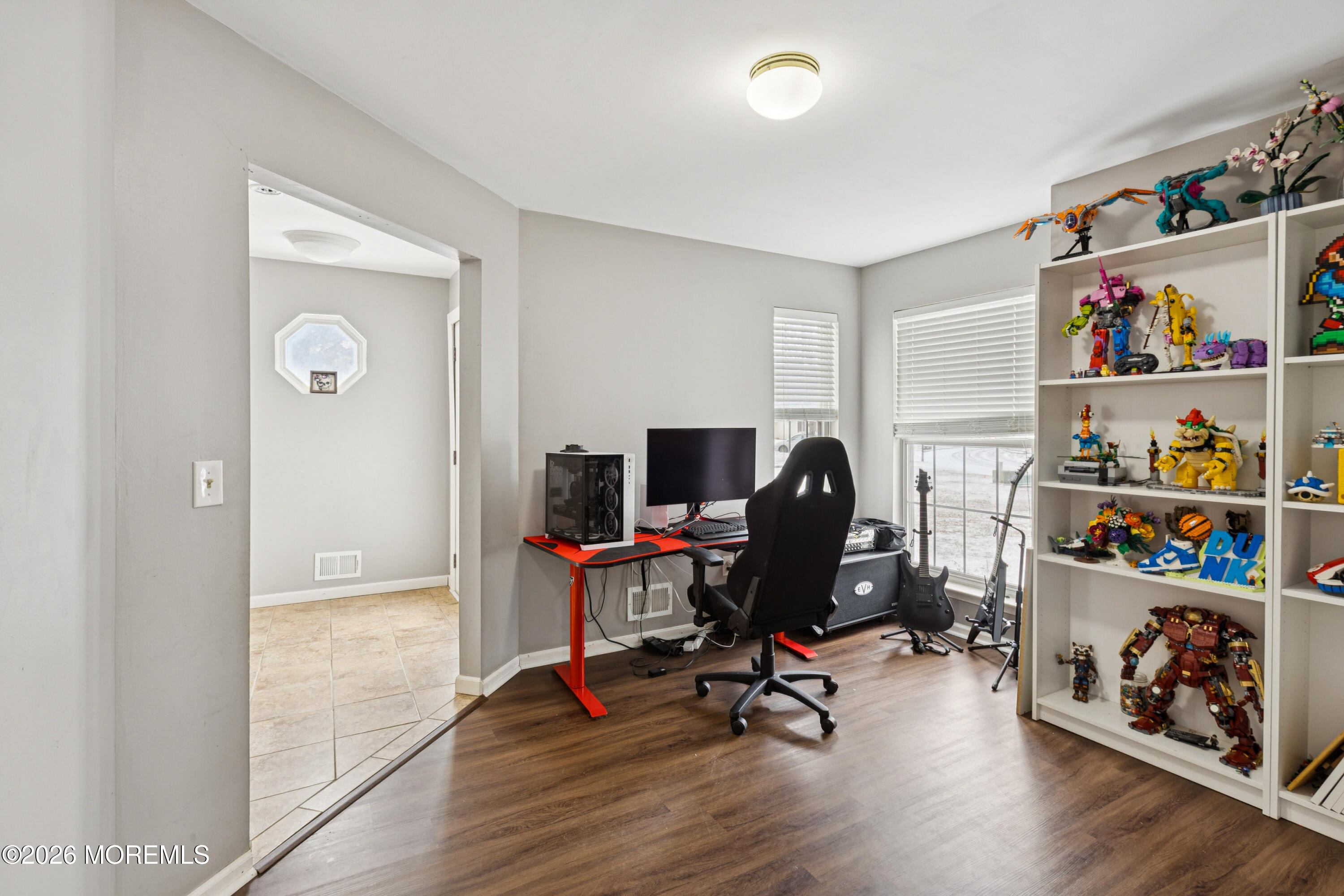 a view of a workspace with furniture and a window