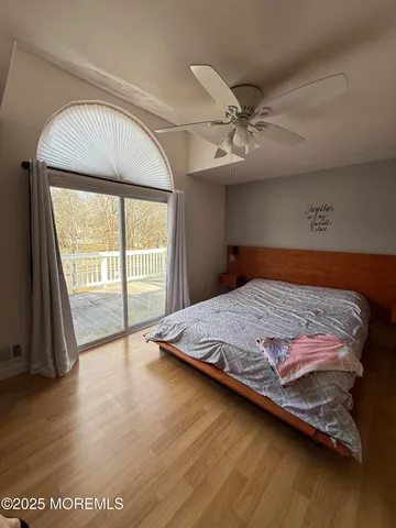 a bed sitting in a bedroom next to a window