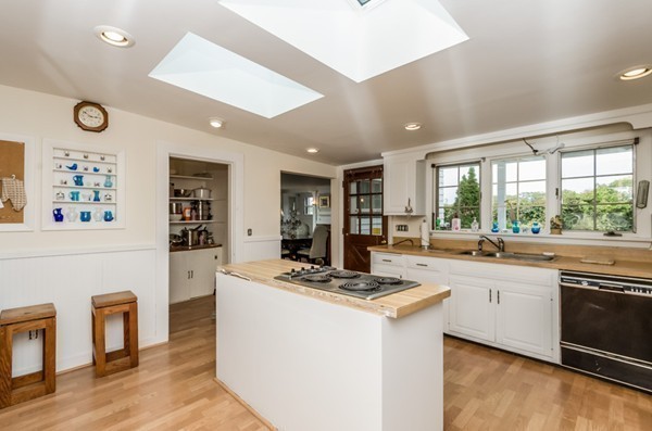 52 Shore Road Gloucester, MA 01930 - Photo 20 of 22 a kitchen with a stove a sink dishwasher and a refrigerator with wooden floor