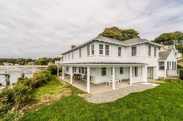 52 Shore Road Gloucester, MA 01930 - Photo 6 of 22 a white house with a large pool and lawn chairs next to a yard