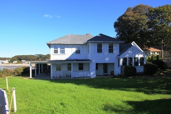 52 Shore Road Gloucester, MA 01930 - Photo 8 of 22 a front view of a house with a garden and yard