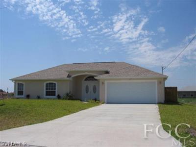 a front view of house with a garden