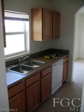 4105 26th Street Southwest Lehigh Acres, FL 33976 - Photo 4 of 5 a kitchen with granite countertop a sink and a stove