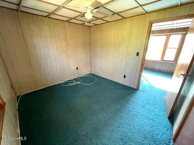 a view of a big room with windows and stairs