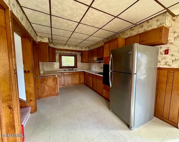 a kitchen with stainless steel appliances granite countertop a refrigerator and a stove