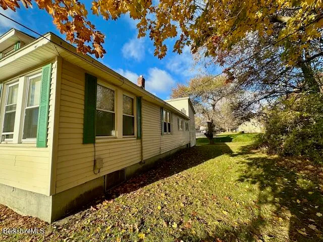 a back view of a house with a yard