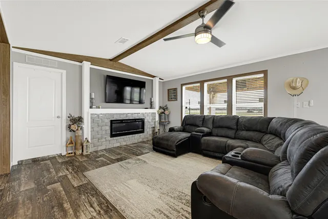 a living room with furniture and kitchen view