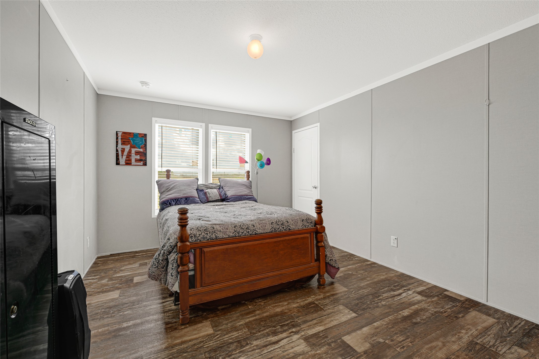 2105 Eagle Road Anahuac, TX 77514 - Photo 39 of 44 a bedroom with a bed and wooden floor