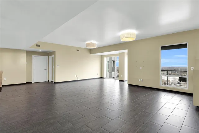 a view of a kitchen with furniture and an empty room