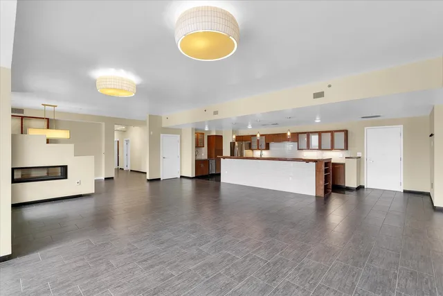 a view of a kitchen with furniture and an empty room