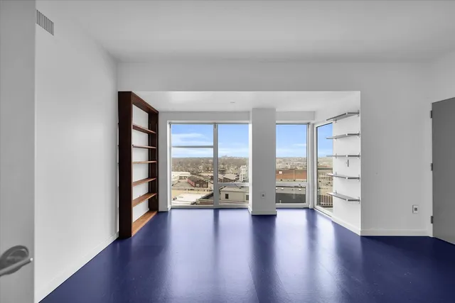 a kitchen with stainless steel appliances granite countertop a refrigerator a sink a stove and a refrigerator