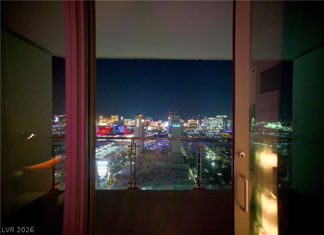 4381 West Flamingo Road, Unit 3616 Las Vegas, NV 89103 - Photo 27 of 29 Cityscape views from a balcony offer a vibrant nightly display.
