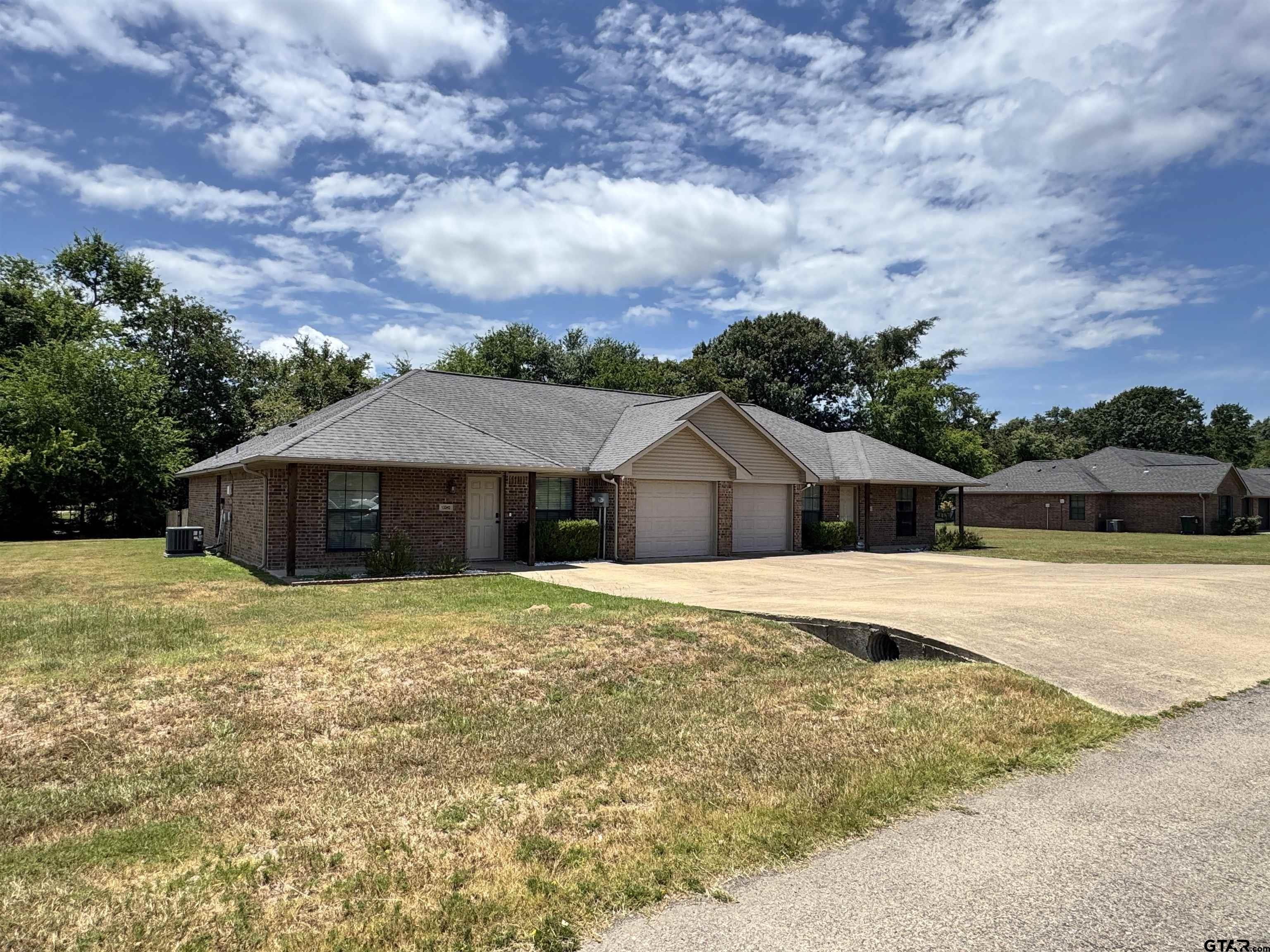 13343 Country Meadow Lane Lindale, TX 75771 - Photo 1 of 20 a front view of a house with a garden