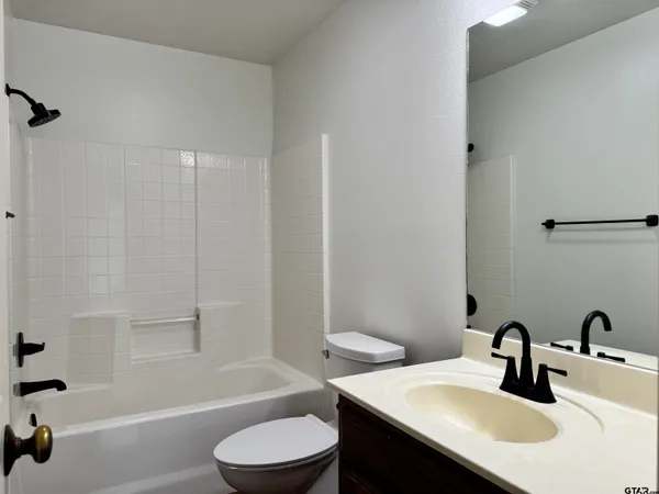 a bathroom with a sink a toilet and a bathtub