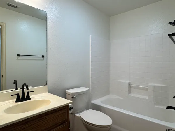 a bathroom with a sink a toilet and bathtub