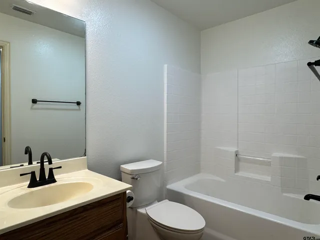 a bathroom with a sink a toilet and bathtub