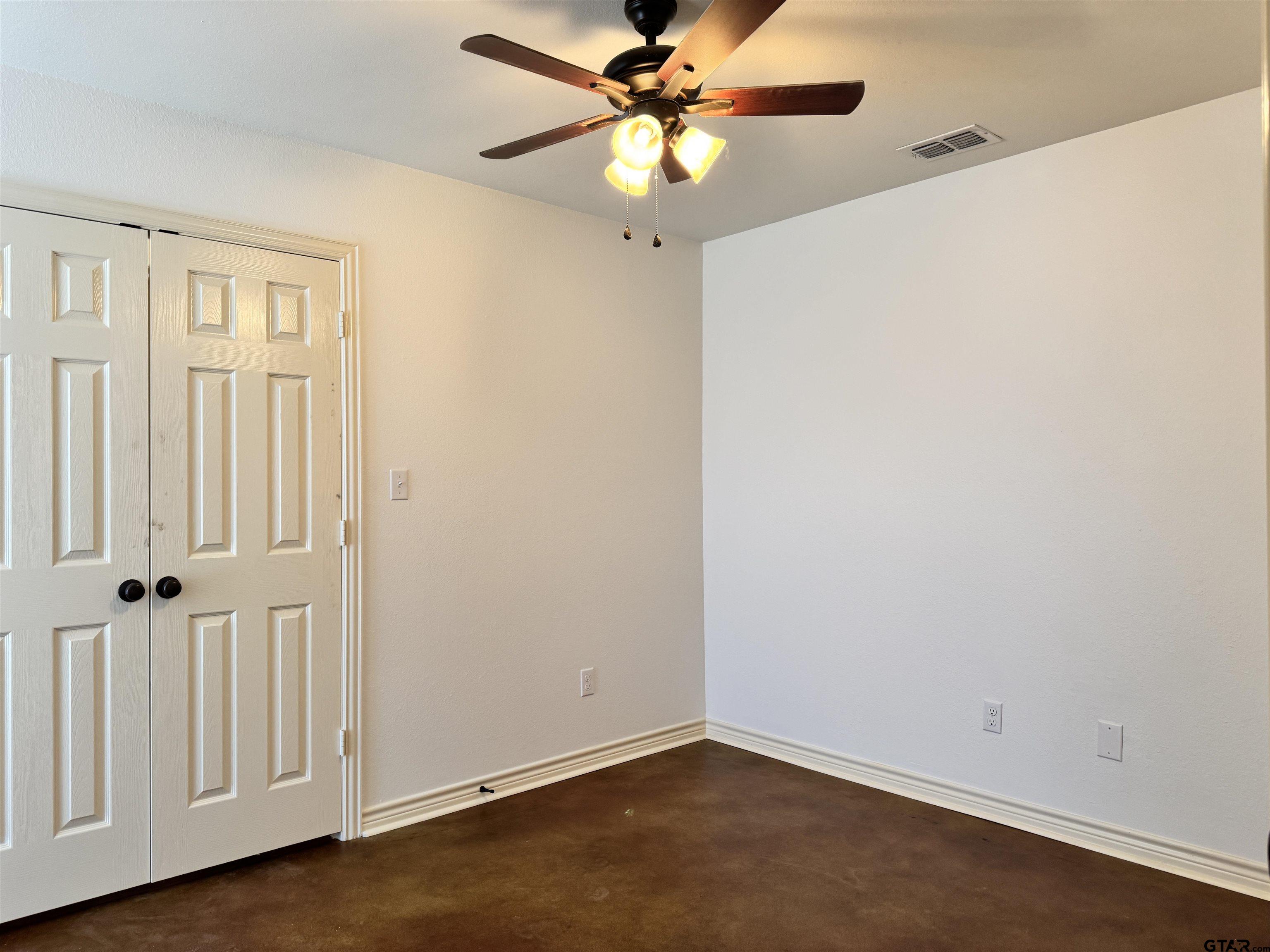 13343 Country Meadow Lane Lindale, TX 75771 - Photo 18 of 20 a view of an empty room with a ceiling fan