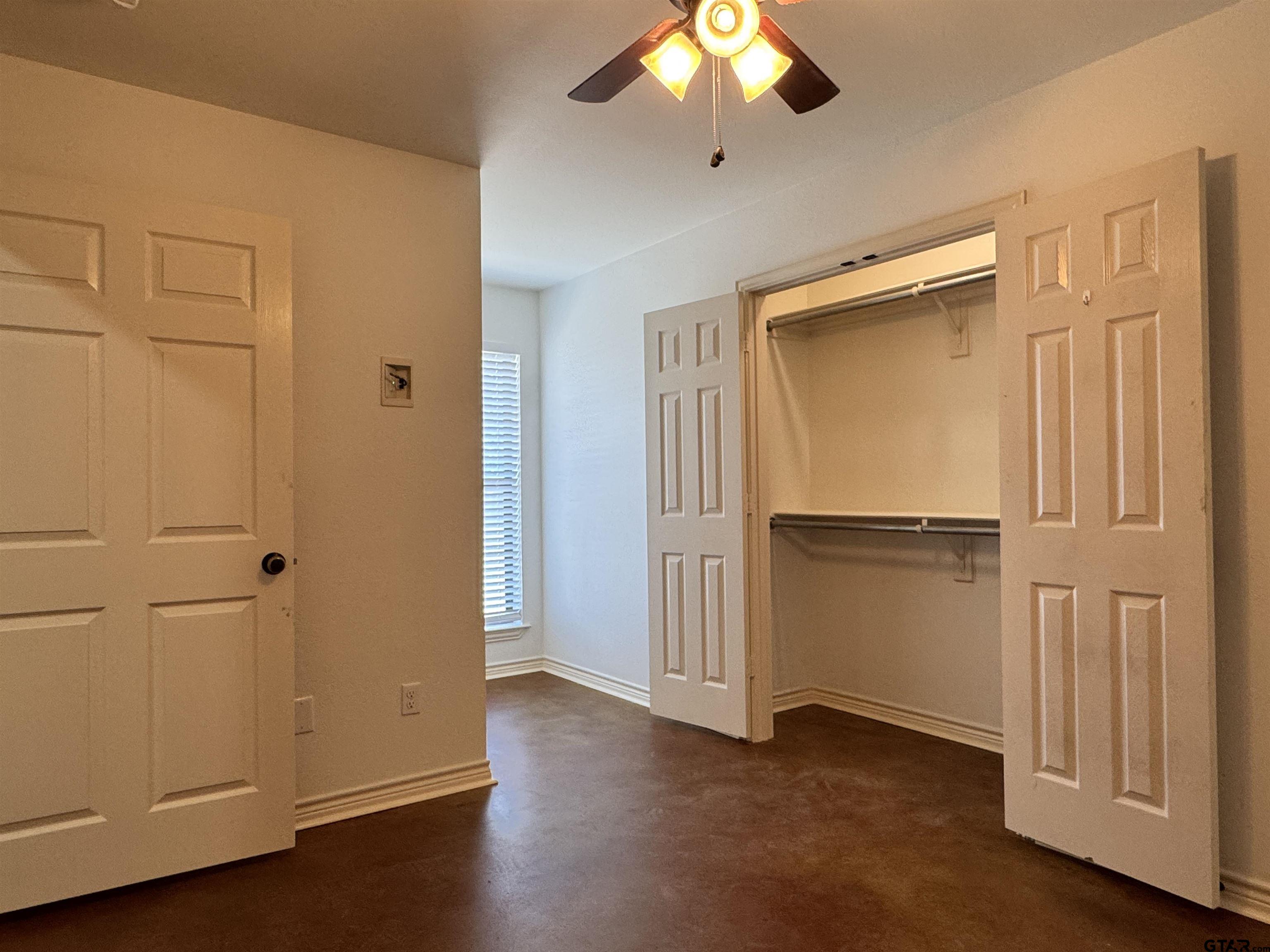 13343 Country Meadow Lane Lindale, TX 75771 - Photo 19 of 20 an empty room with wooden floor closet and windows