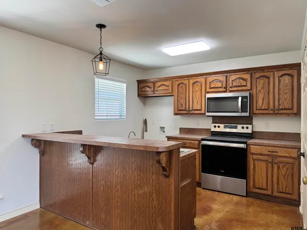 a kitchen with stainless steel appliances a sink stove and microwave