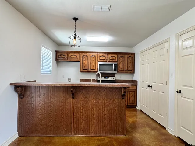 a view of cabinets and wooden floor