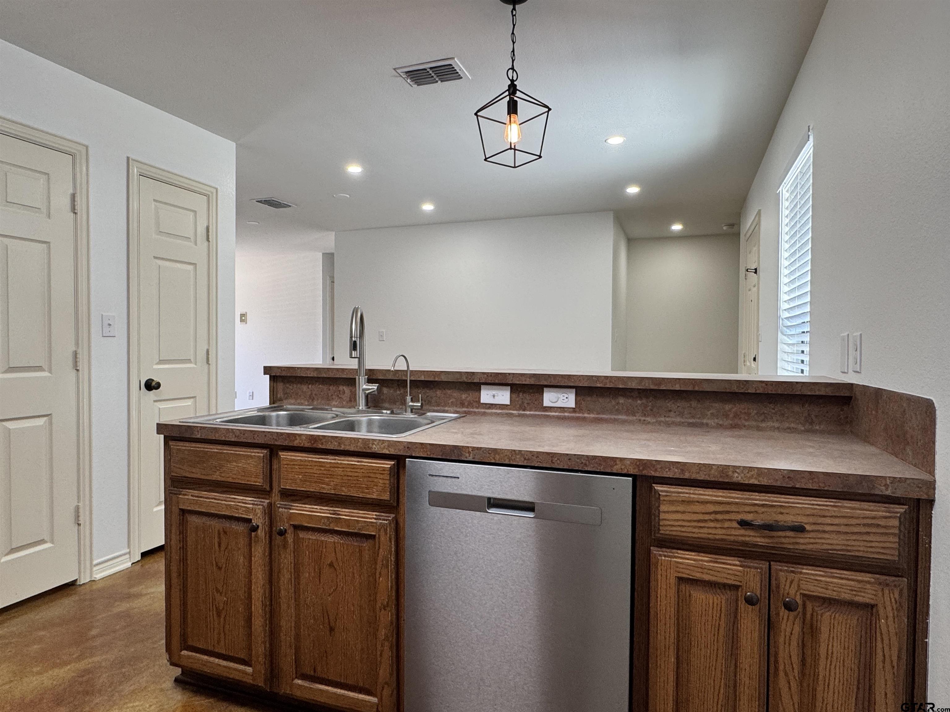 13343 Country Meadow Lane Lindale, TX 75771 - Photo 7 of 20 a kitchen with a sink and a refrigerator