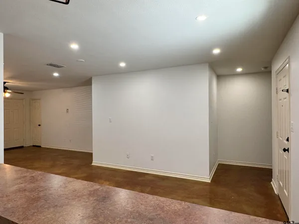 an empty room with wooden floor